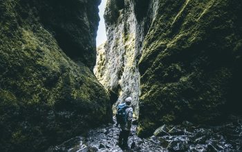 Wallpaper Man Standing Between Rock Formations