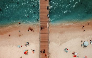 Wallpaper Bird’s-Eye View of Brown Wooden Dock on Water