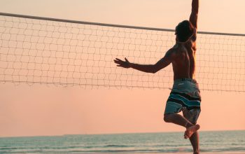 Wallpaper Man Playing Beach Volleyball During Daytime