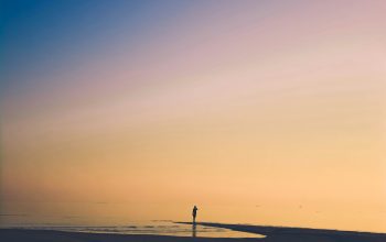 Wallpaper Person Standing on Beach Shore During Golden Hour