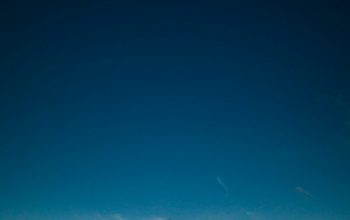 Wallpaper Body of Water Under Clear Blue Sky Painting