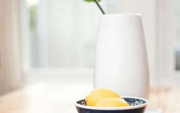 Wallpaper Round Black Bowl Beside Vase on Table
