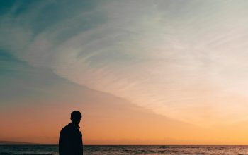 Wallpaper Silhouette Person Standing Beside Seashore During Sunset