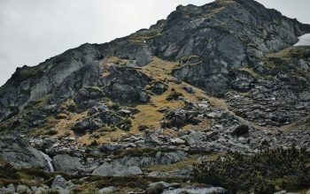 Wallpaper Rocks and Mountain Under White Sky