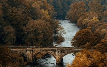 Wallpaper Aerial Photography of Brown Historic Bridge Viewing Lake Under White and Gray Sky During Daytime