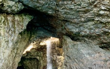 Wallpaper A Cave with a Waterfall