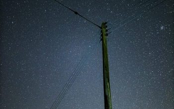 Wallpaper Black Electric Post Under Blue Night Sky