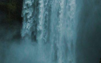 Wallpaper People Standing Near Waterfalls During Daytime