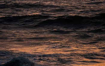 Wallpaper Ocean Waves Crashing on Shore During Sunset