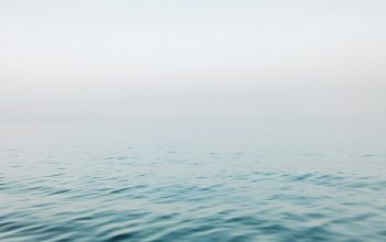 Wallpaper Body of Water Under White Sky During Daytime