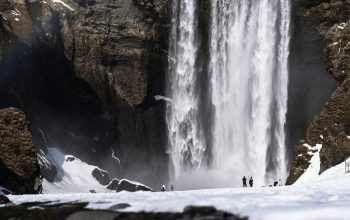 Wallpaper Waterfalls on Brown Rocky Mountain During Daytime