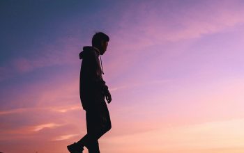 Wallpaper Silhouette of Man on Hill at Sunset