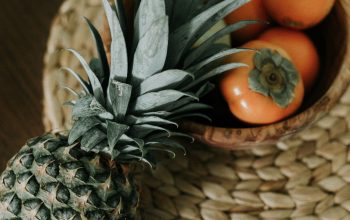 Wallpaper Brown and Green Pineapple Fruit on Brown Woven Basket