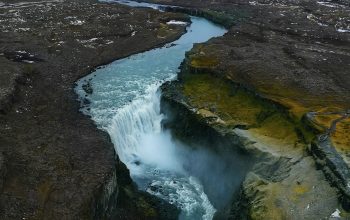 Wallpaper Waterfall on Brown Rocky Mountain