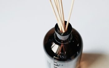 Wallpaper Black Glass Bottle with Brown Wooden Sticks