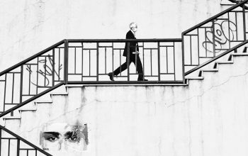 Wallpaper Man in Black Jacket and Pants Walking Downstairs