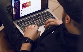 Wallpaper Man in Black Jacket Using Macbook Pro
