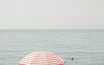 Wallpaper A Couple Under a Beach Umbrella