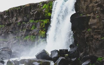 Wallpaper Waterfall on Rocky Mountain During Daytime
