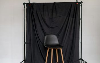 Wallpaper A Chair Against a Black Background
