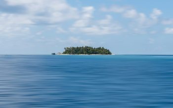Wallpaper A Small Island in the Middle of the Ocean