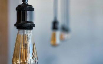 Wallpaper A Group of Light Bulbs Hanging from a Ceiling