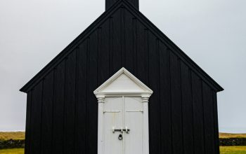 Wallpaper A Black and White Church with a Steeple