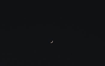 Wallpaper A View of the Moon and a Distant Celestial Object