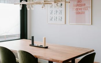 Wallpaper A Wooden Table with Green Chairs in a Room