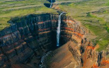 Wallpaper An Aerial View of a Waterfall in a Canyon