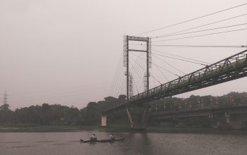 Wallpaper A Bridge Over Water with a Boat