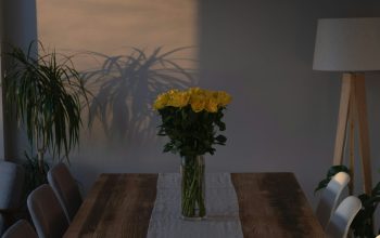 Wallpaper A Wooden Table with a Vase of Flowers