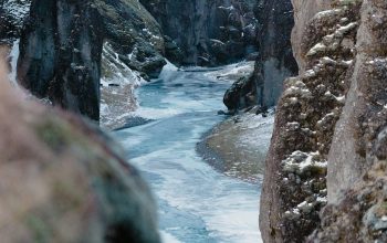 Wallpaper A River Between Large Rocks