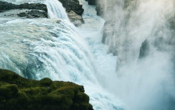 Wallpaper A Large Waterfall Pouring Water