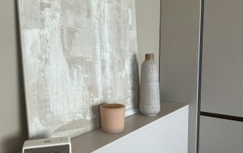 Wallpaper A Painting on a Wall Above a White Cabinet