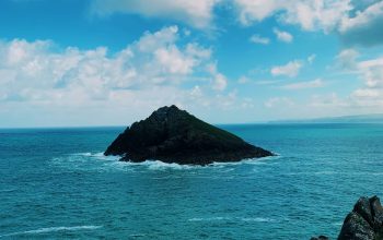 Wallpaper A Rocky Island in the Ocean