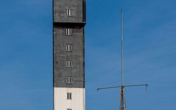 Wallpaper A Tall Tower with an Antenna