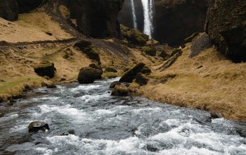 Wallpaper A Waterfall in a Rocky Canyon