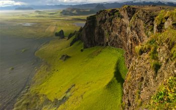 Wallpaper A Cliffside Overlooking Water