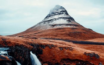 Wallpaper A Mountain with a Waterfall
