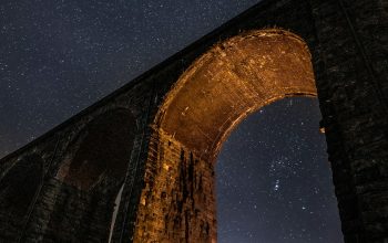 Wallpaper A Stone Bridge with a Starry Sky