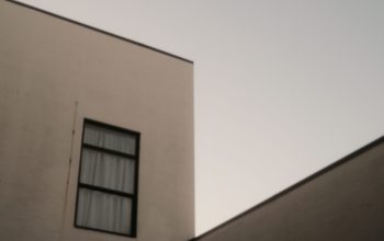 Wallpaper A Building with Two Windows and a Sky