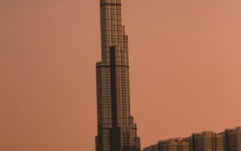 Wallpaper A Very Tall Building Towering Over a City