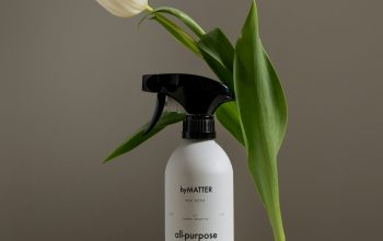 Wallpaper A Bottle of Deodorant Next to a Flower