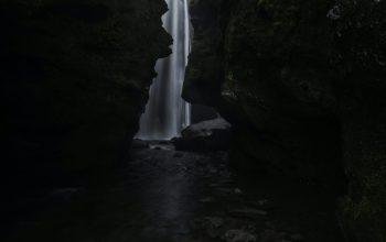 Wallpaper A Small Waterfall in the Middle of a Forest