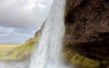 Wallpaper A Large Waterfall Cascading from a Mountainside