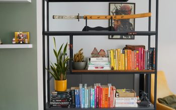Wallpaper A Bookshelf Filled with Lots of Books Next to a Yellow Chair