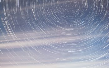 Wallpaper A Star Trail Over a Highway