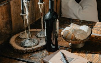 Wallpaper A Wooden Table Topped with a Bottle of Wine