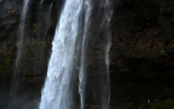 Wallpaper A Very Tall Waterfall with Lots of Water